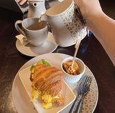 Foto Hot Tea + Egg Croissant di Sadrasa Kitchen & Bar - Hotel Pullman Bandung Grand Central